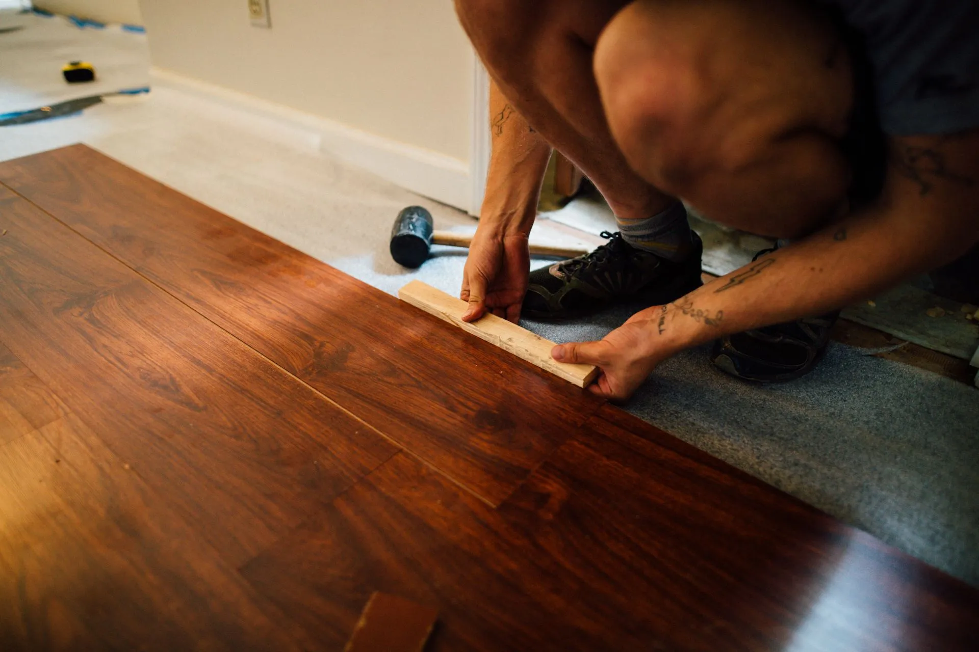Installer laying plank flooring